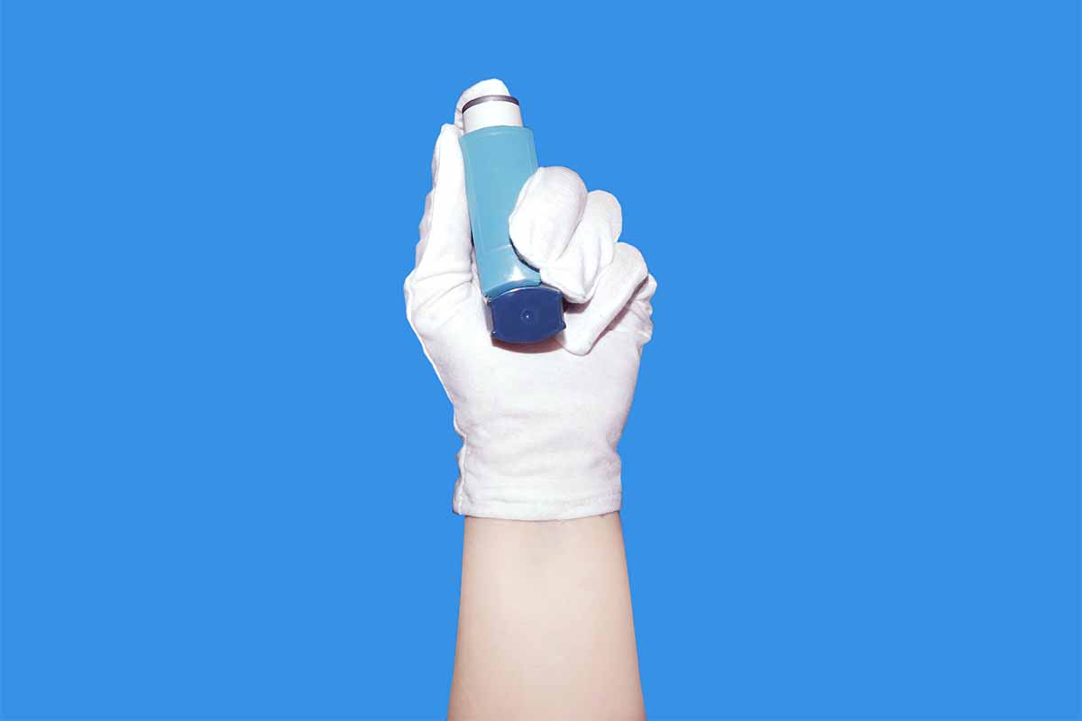 Hand holding inhaler